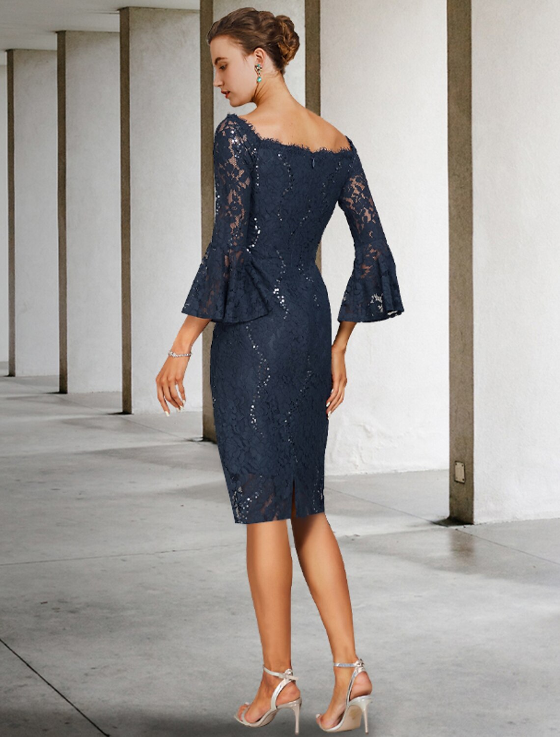 Side profile of the two-piece formal dress, highlighting the knee-length skirt and elegant silhouette.