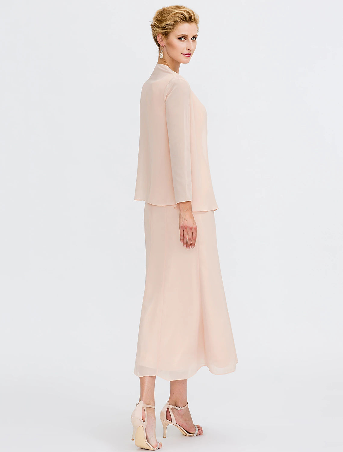 Close-up of the chiffon fabric, pleats, and beading on the elegant two-piece dress.