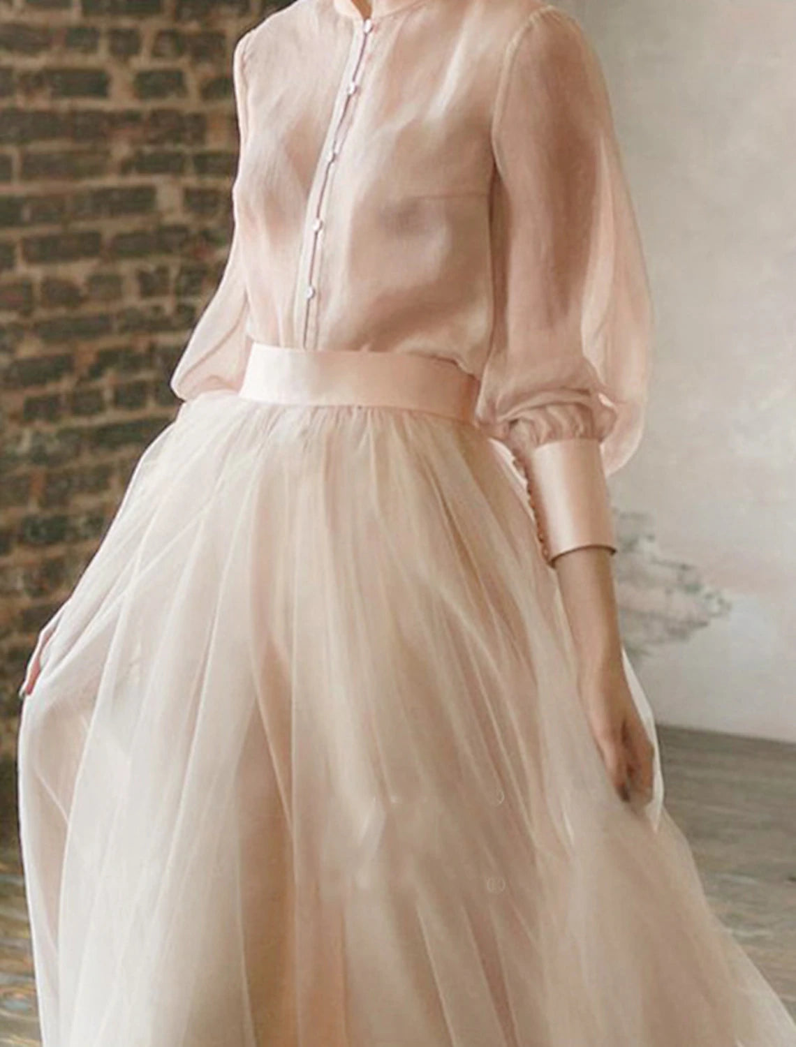 Close-up of the stand collar and long sleeves on the formal two-piece dress.