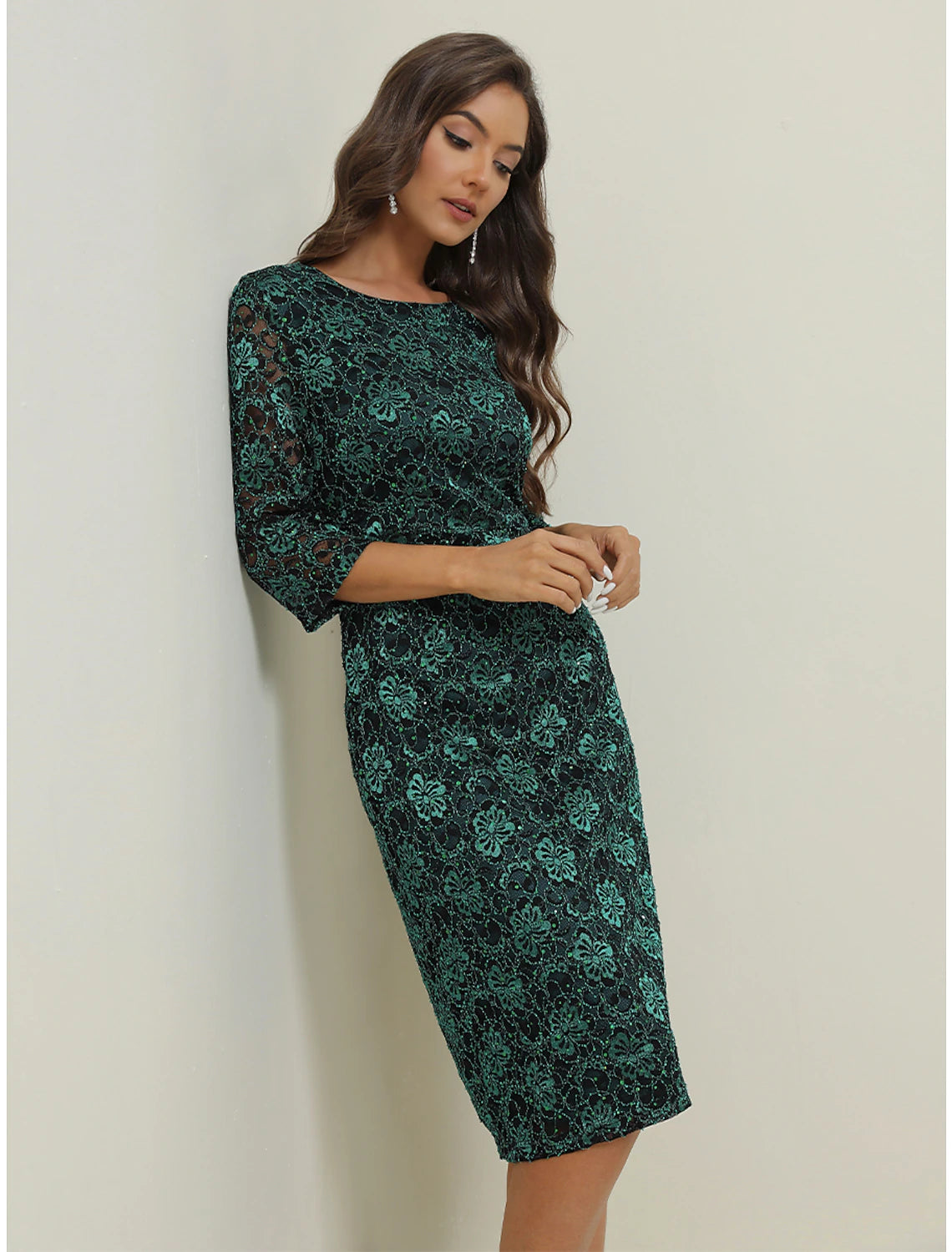 Back view of a woman wearing the elegant green two-piece lace maxi dress.