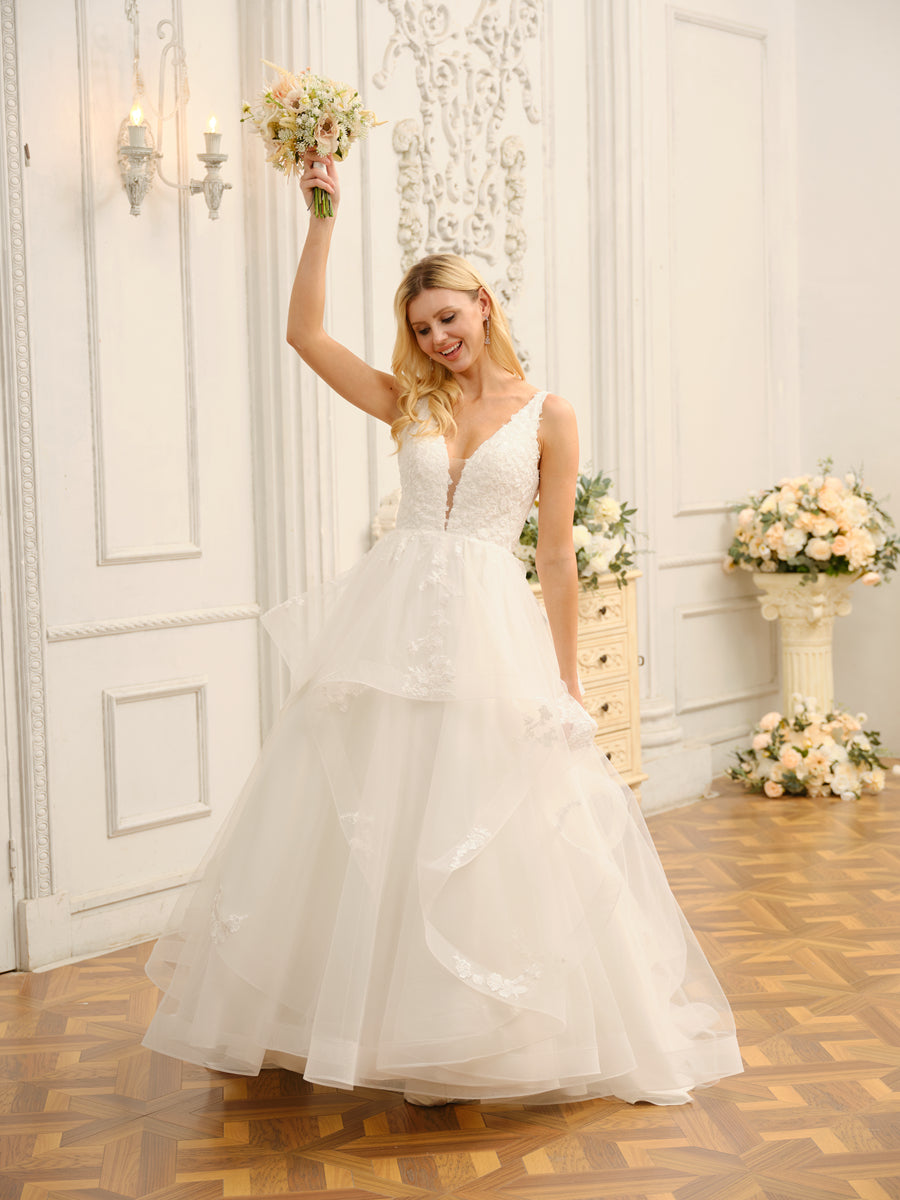 Close-up detail of the delicate appliques on the V-neck ball gown wedding dress.