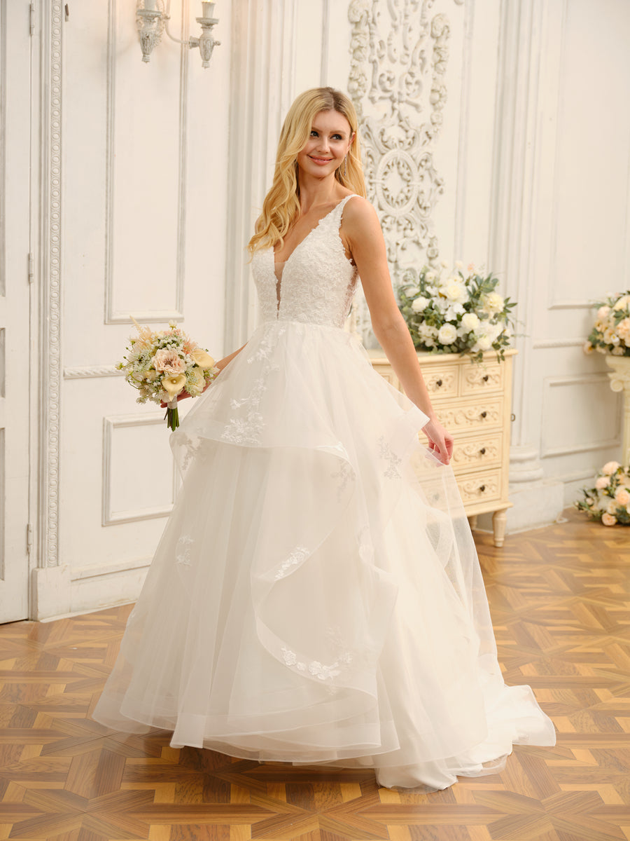 Full length view of a bride in the stunning V-neck ball gown wedding dress.