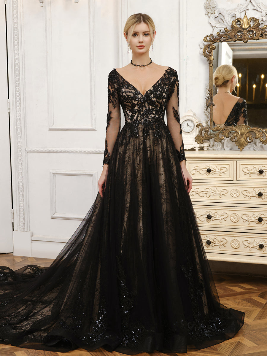 Bride wearing an elegant V-neck long sleeve beaded tulle wedding dress.