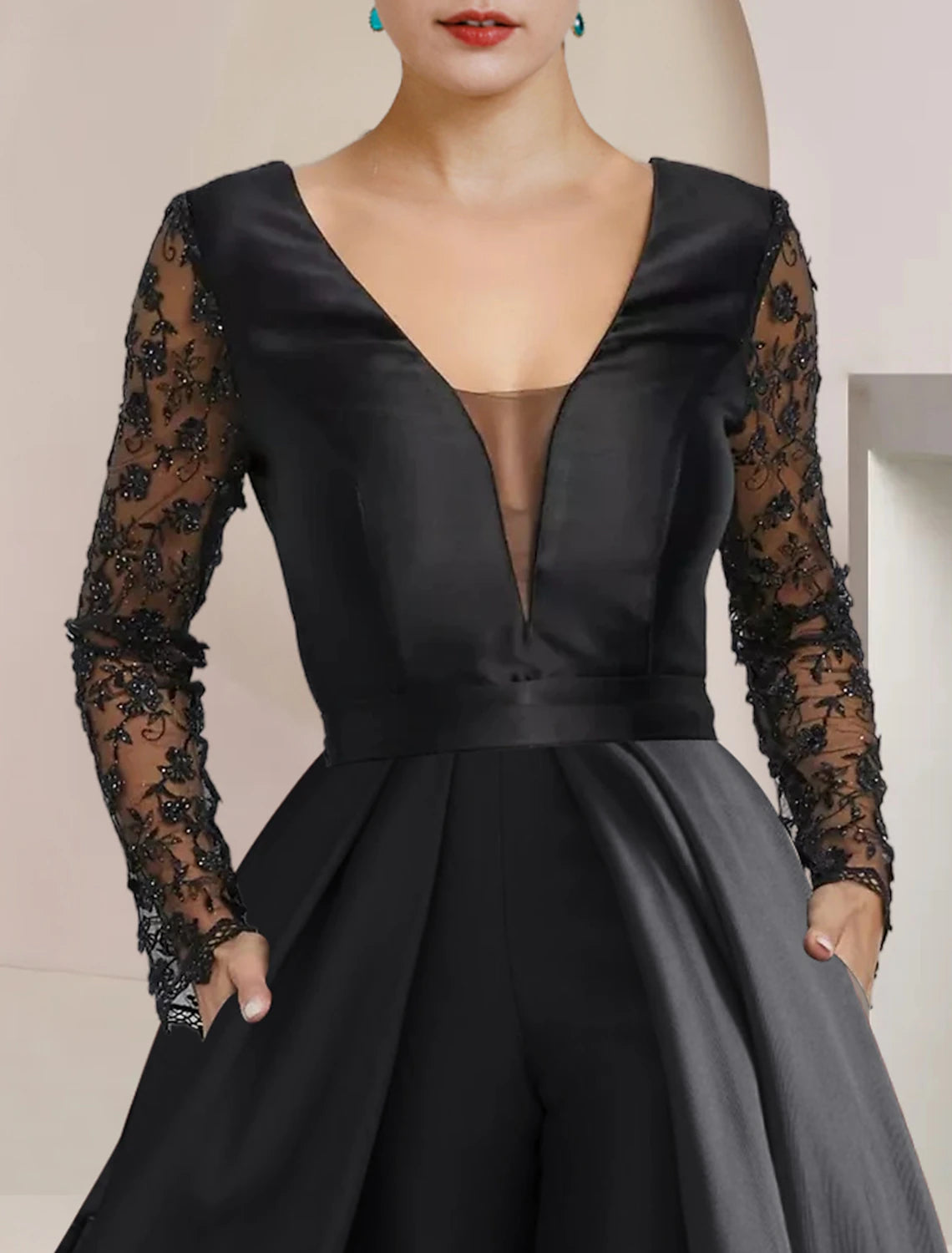 Close-up of the satin lace fabric and applique embellishments on the dress.