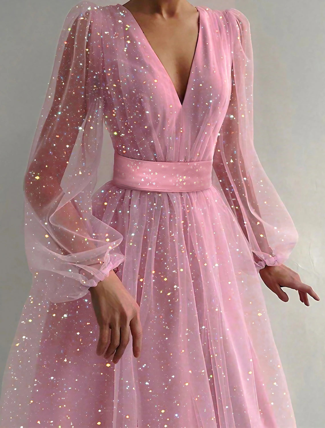 Woman wearing a pink apricot V-neck long sleeve mesh midi dress, suitable for parties.
