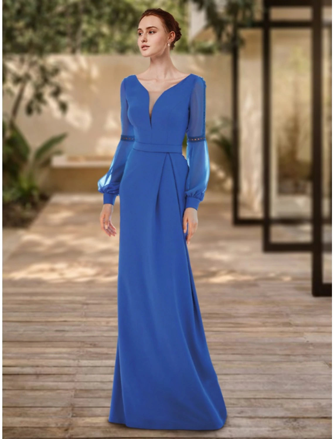 Woman wearing an elegant V-neck long sleeve sheath evening gown with pleats, front view.