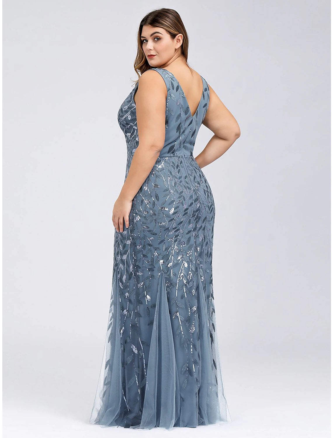 Back view of a floor-length tulle prom dress with delicate appliques.