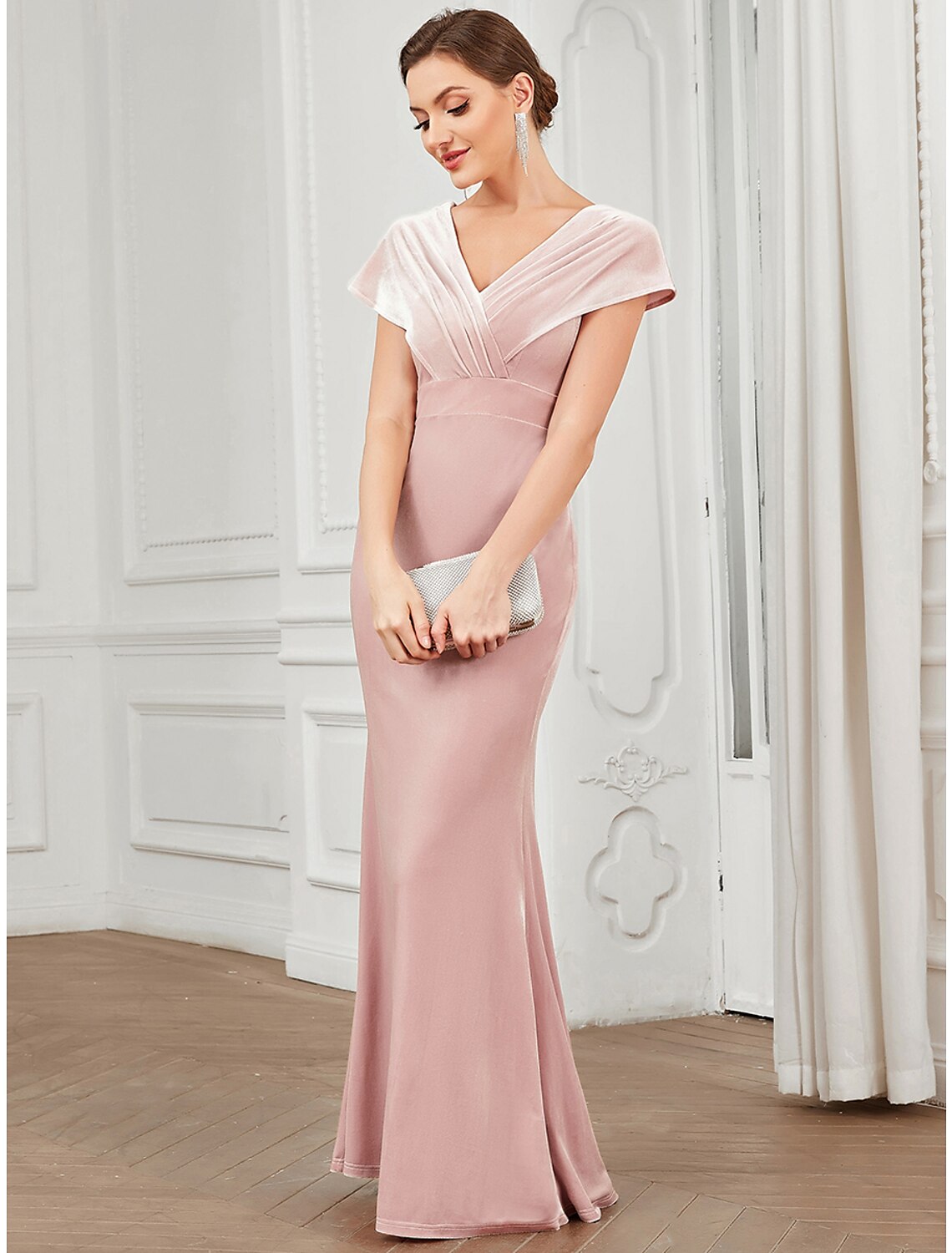 Model wearing a Weitese elegant velvet mermaid evening gown with short sleeves and a V-neck.