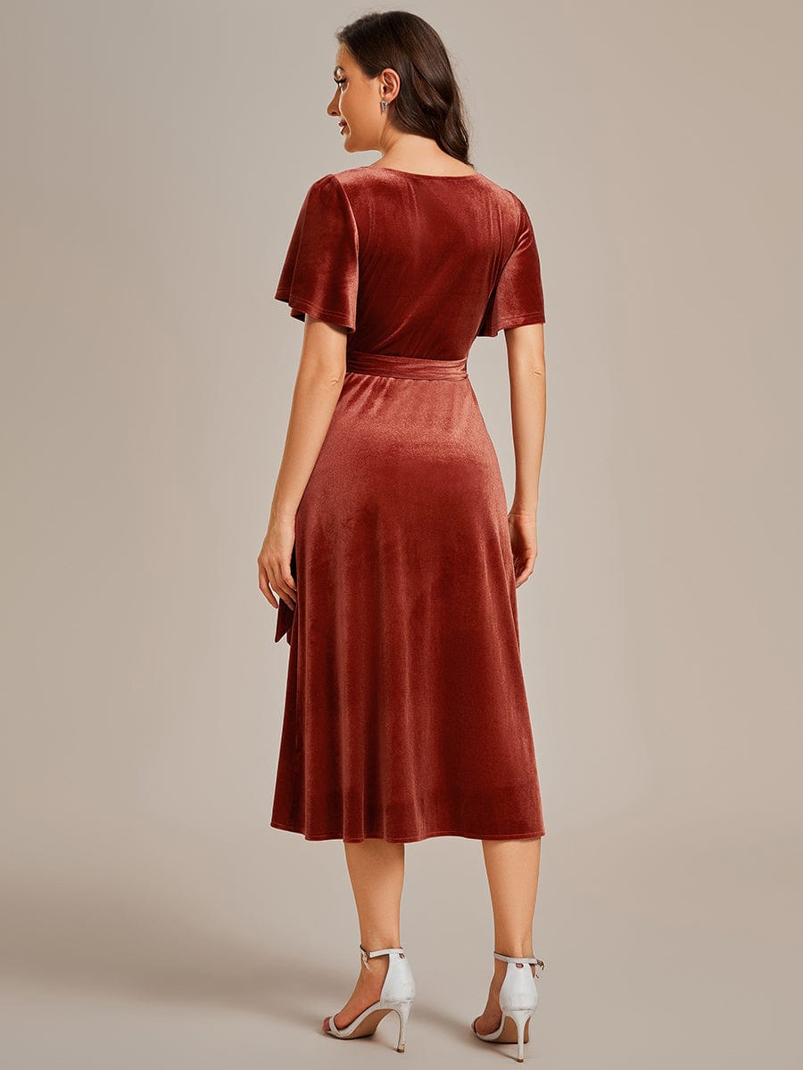 Red velvet midi dress with V-neck and short sleeves, side profile.