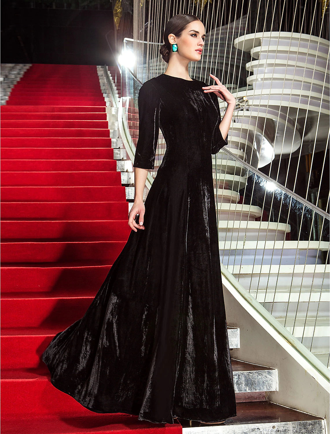 Front view of an elegant A-line black velvet dress with 3/4 sleeves.