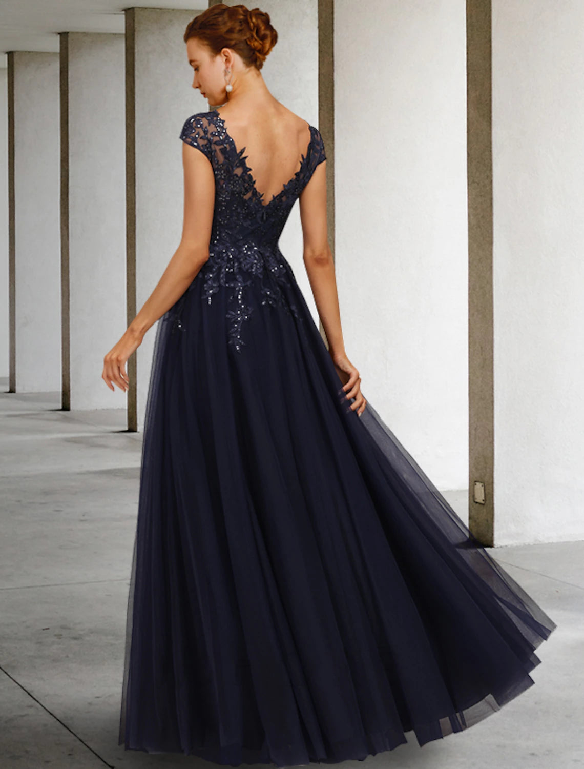 Side view of the vintage sequined A-line gown with floor-length tulle.