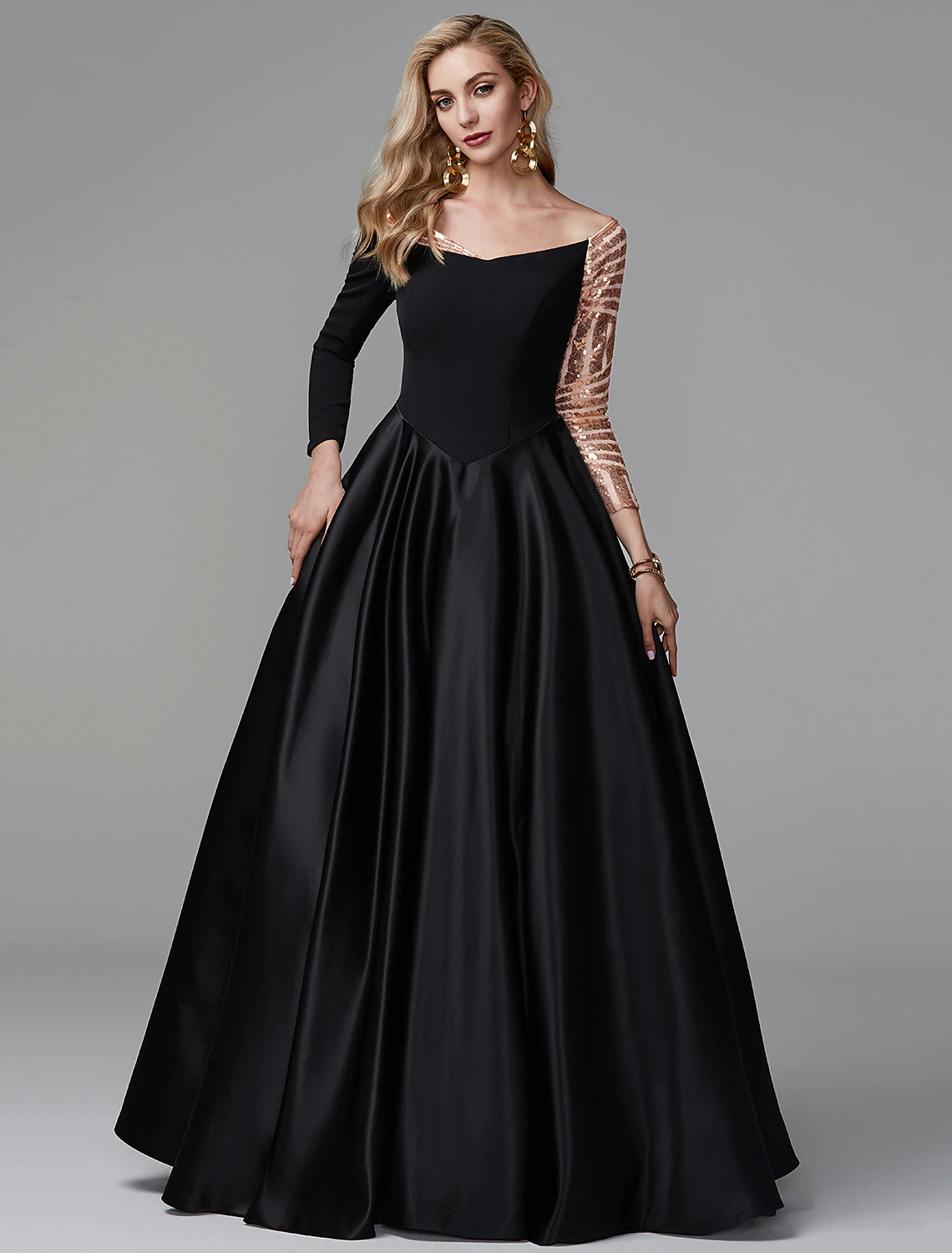 Woman wearing a long sleeve off-shoulder satin ball gown with sequin details.