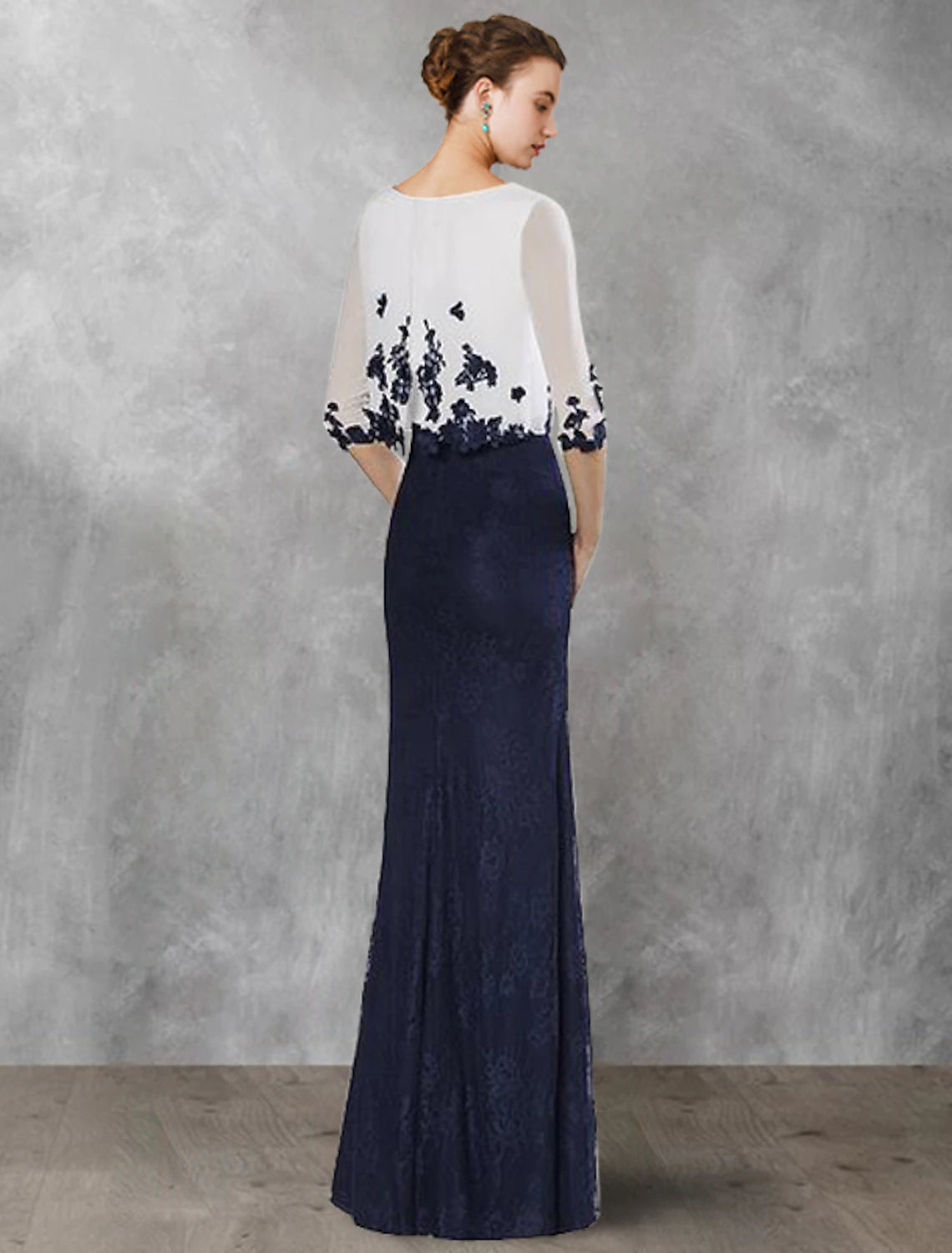 Woman wearing a vintage-style jewel neck half sleeve formal gown.