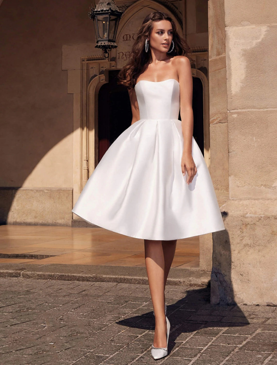 Woman modeling a Weitese A-line strapless knee-length cocktail dress.