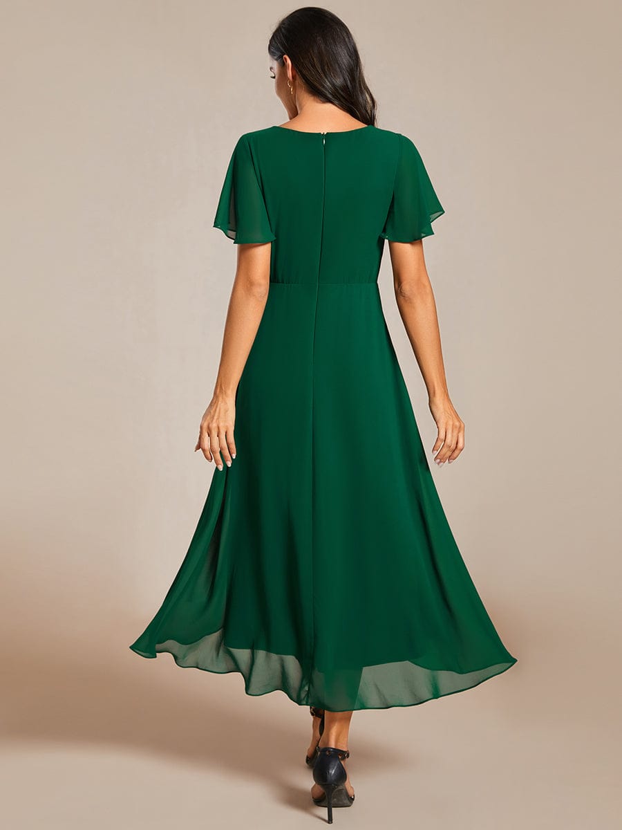 Side view of Weitese pleated chiffon dress in dark green.