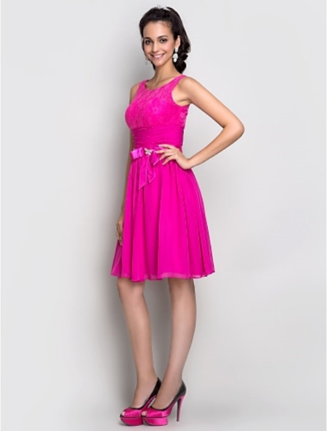Back view of the dark blue Weitese cocktail dress, highlighting the scoop neck and bow embellishments.