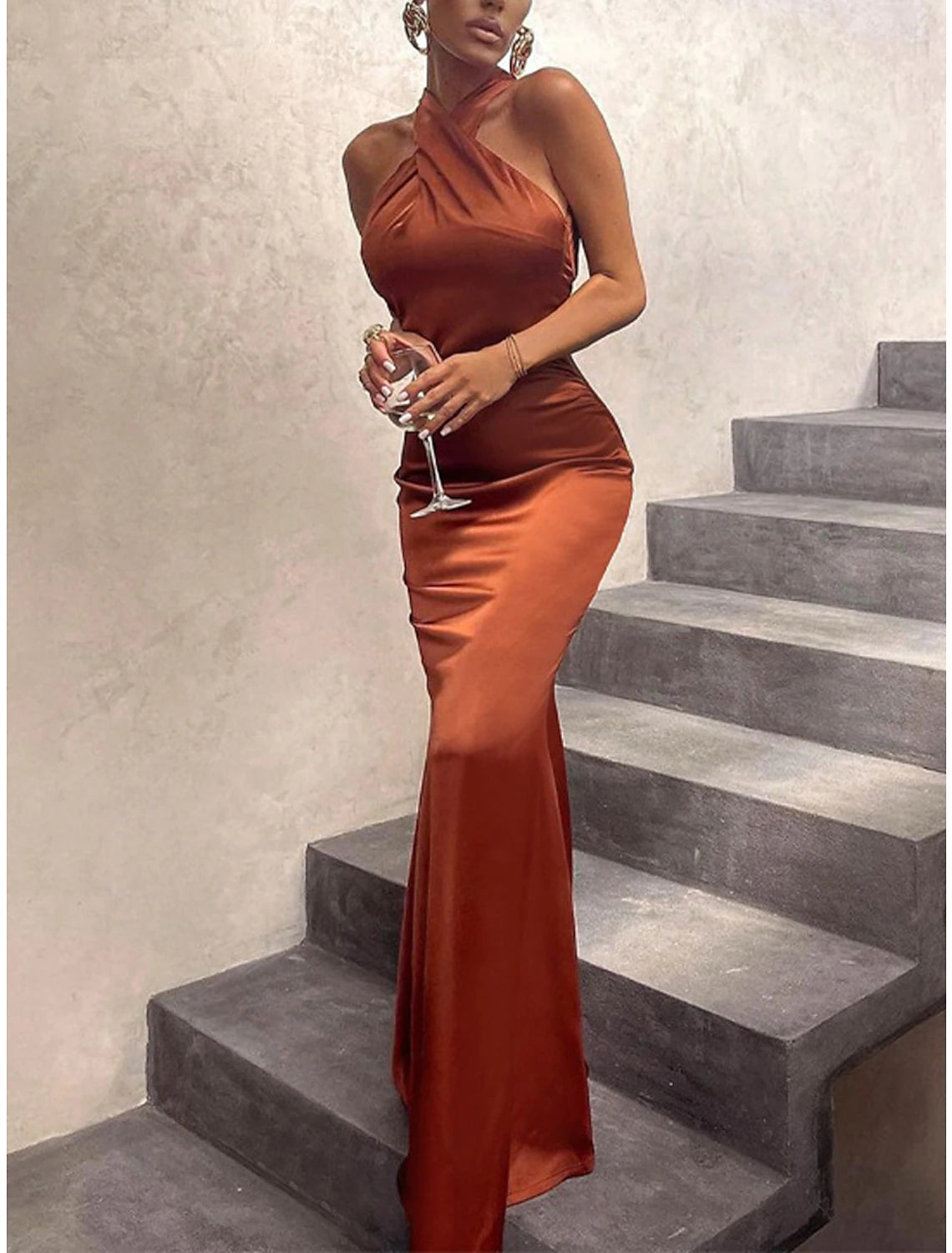 Woman in a black halter neck bodycon maxi dress.