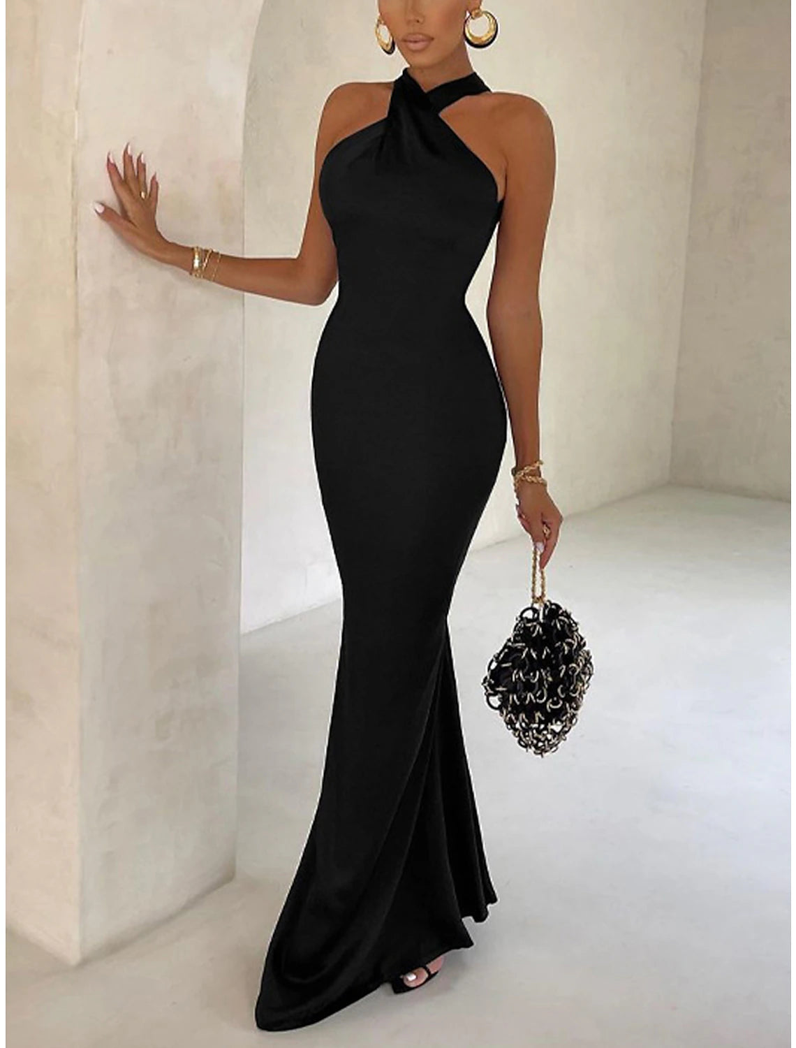Close-up of a black halter neck bodycon dress fabric.