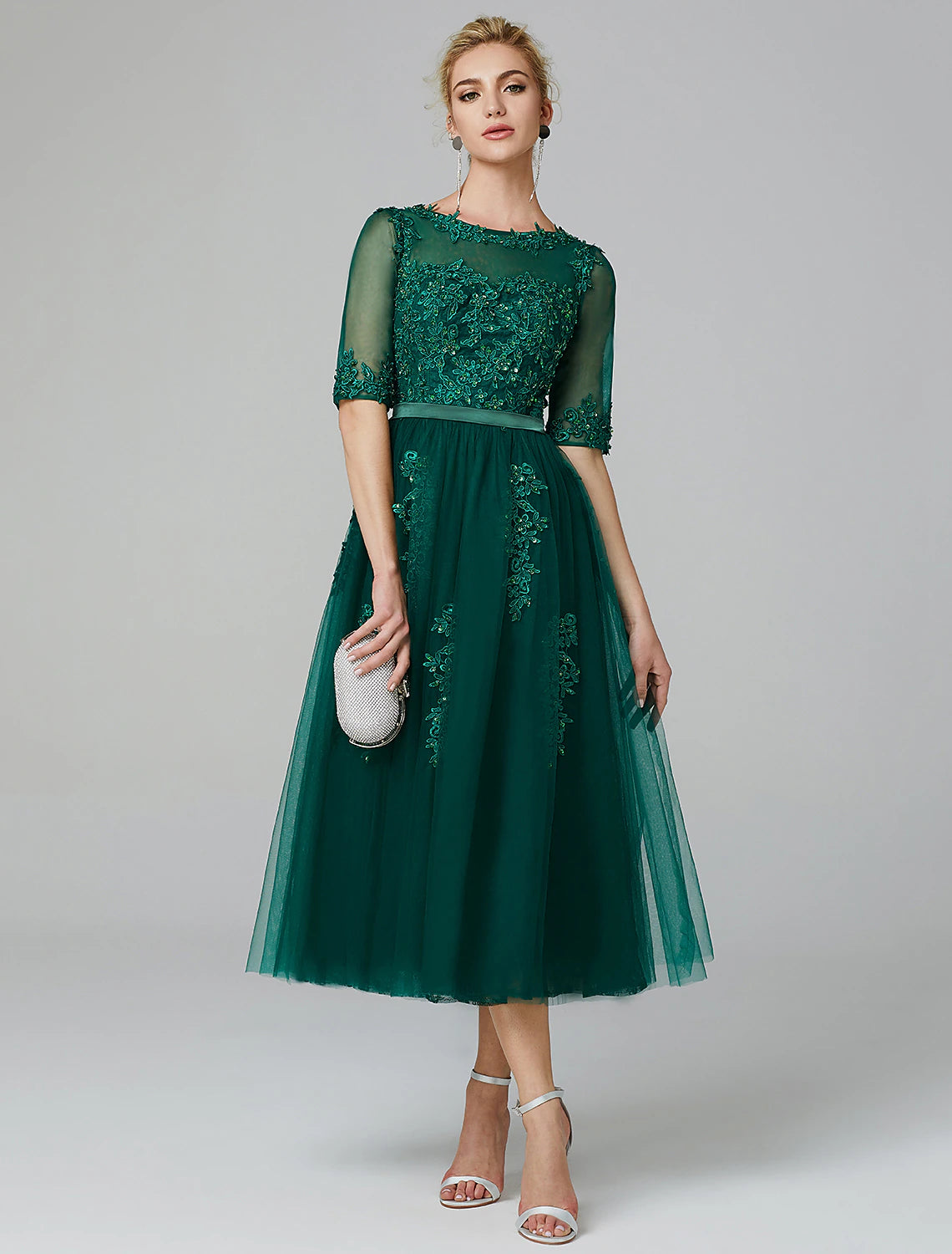 Red and green A-line dress with illusion neck and lace appliques.