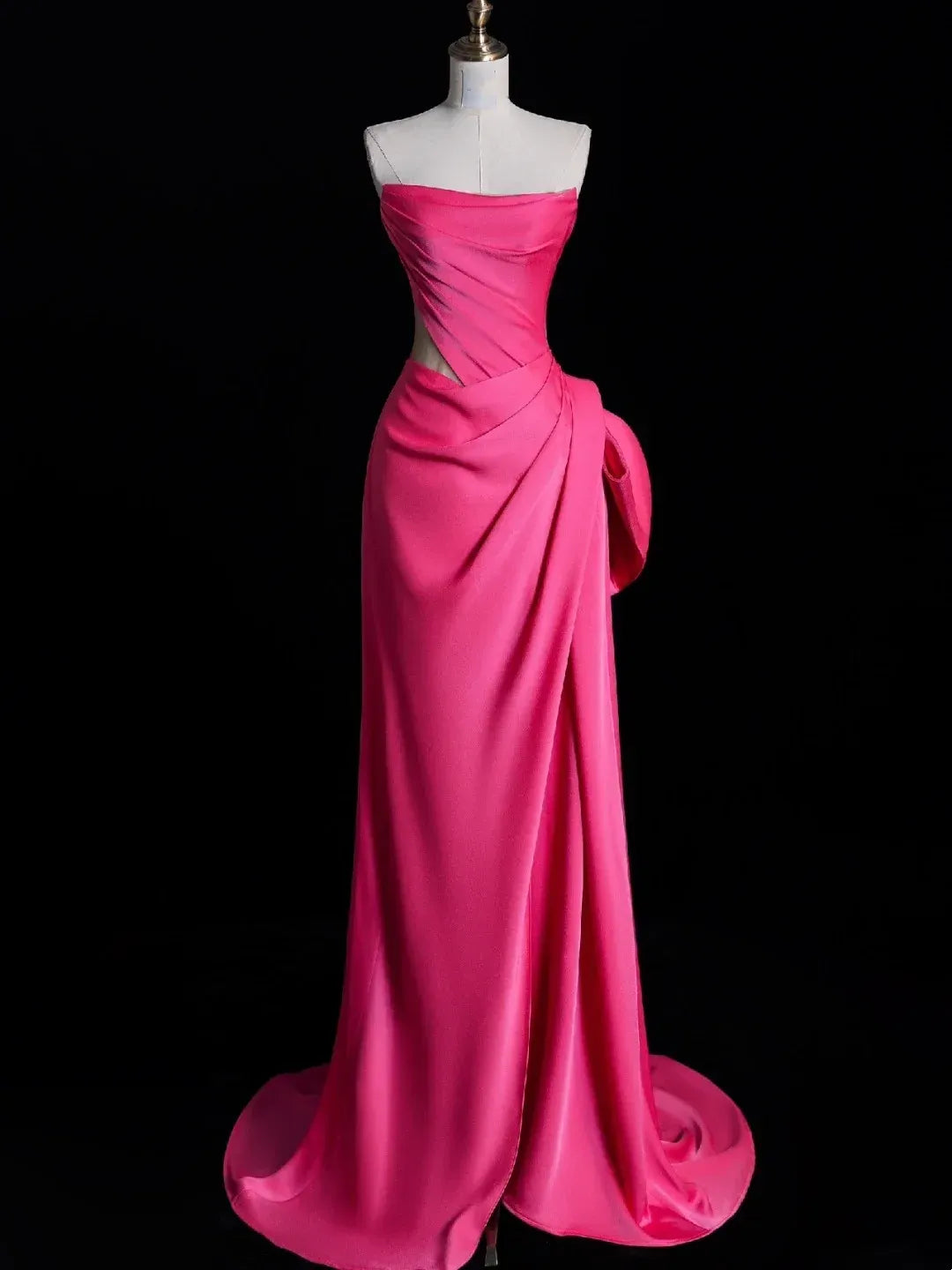 Fuchsia satin mermaid evening dress with oversized bow, front view.