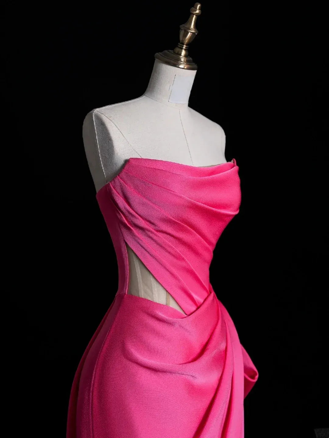 Close-up of fuchsia satin fabric and ruched strapless bodice.