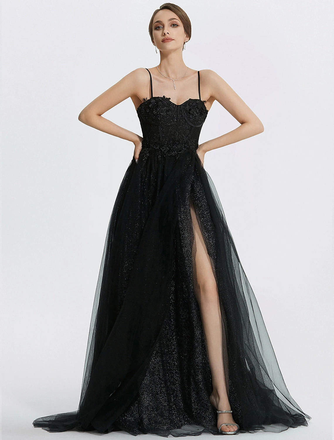 Back view of a glittering A-line floor-length prom dress with a flowing tulle skirt.