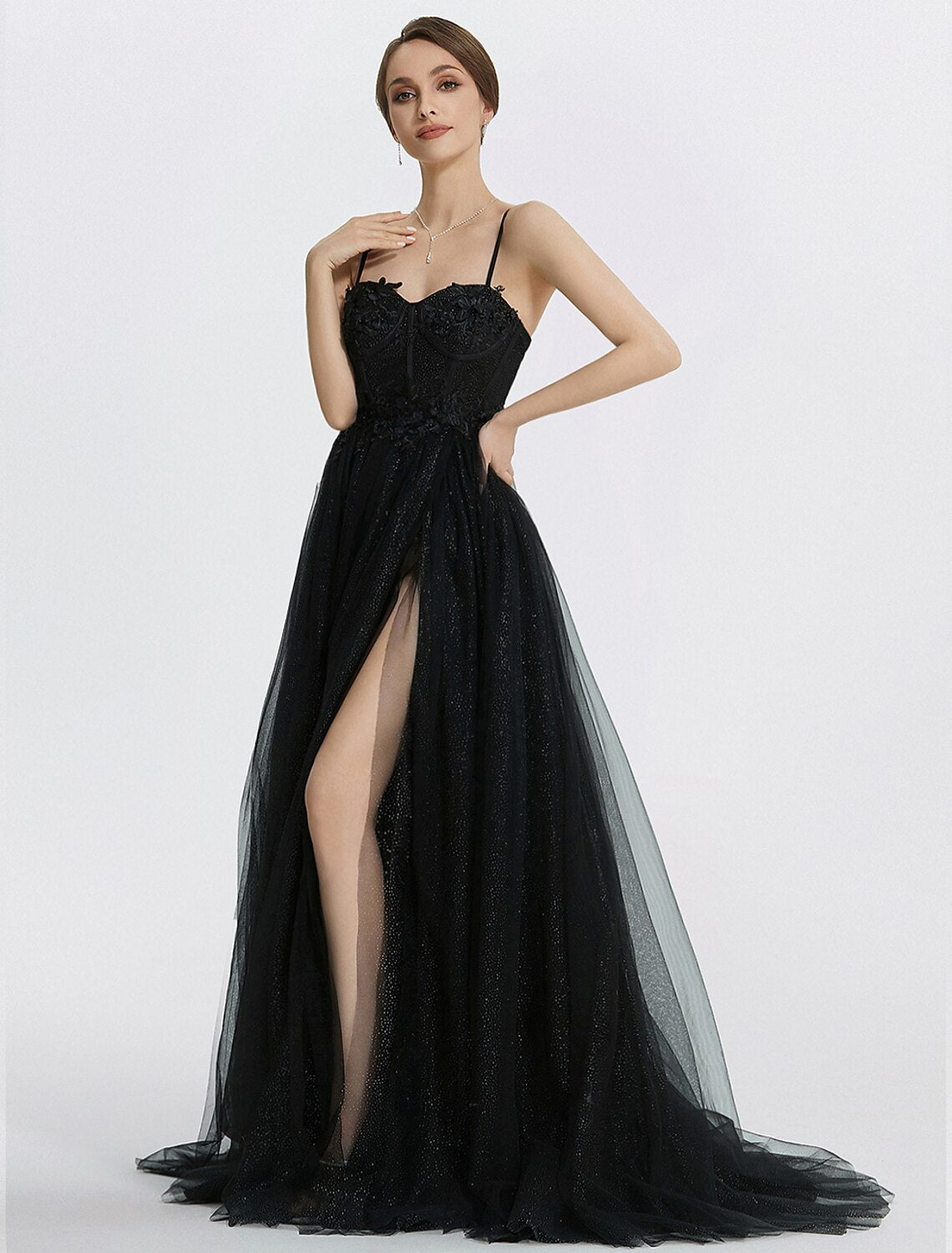 Close-up of the glittering fabric and intricate applique details on the prom dress.