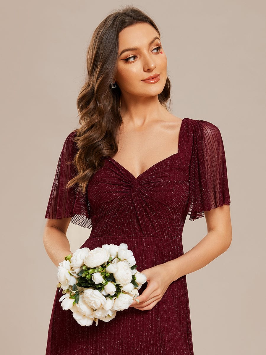 Back view of the glittery A-line bridesmaid dress, showcasing the lace-up detail.