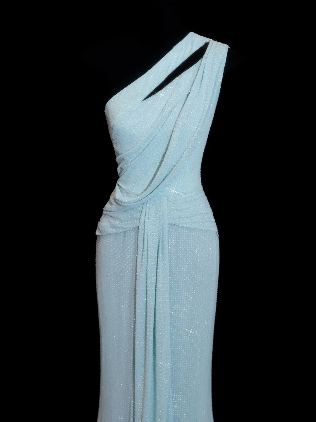 Detail of the one-shoulder cutout and ruched waist on the icy blue shimmer mermaid dress.