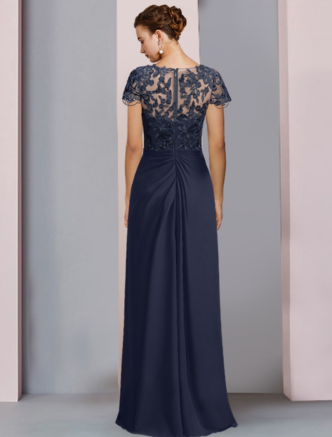 Back view of a formal floor-length sheath gown with sequin details.