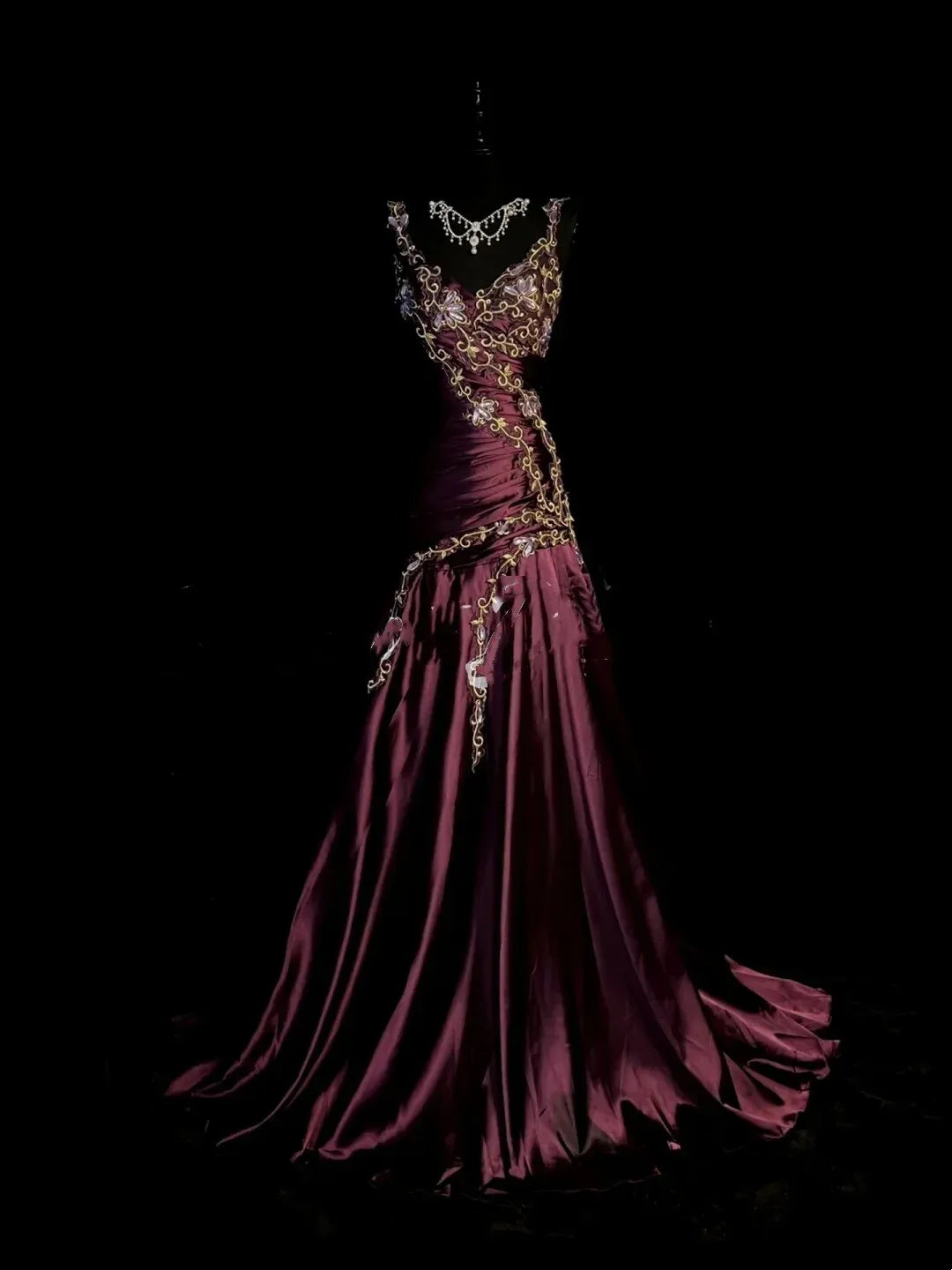 Elegant plum satin mermaid gala dress with golden floral embroidery.