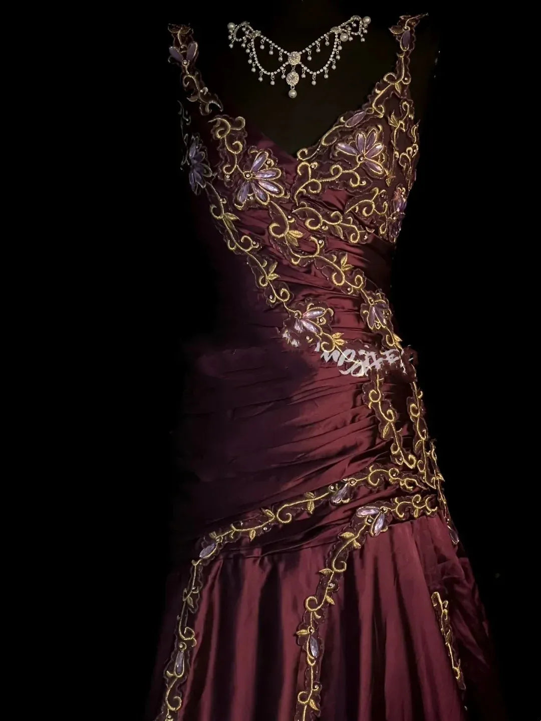 Back view of floor-length plum mermaid evening gown.
