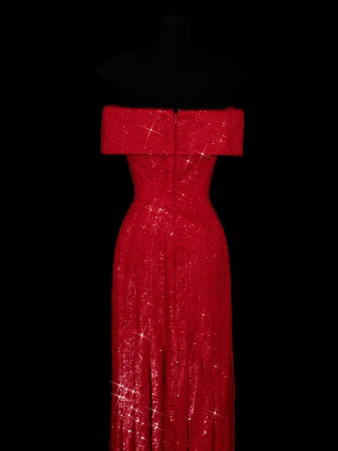Close-up of the ruched bodice and sparkling sequin fabric on the red evening dress.