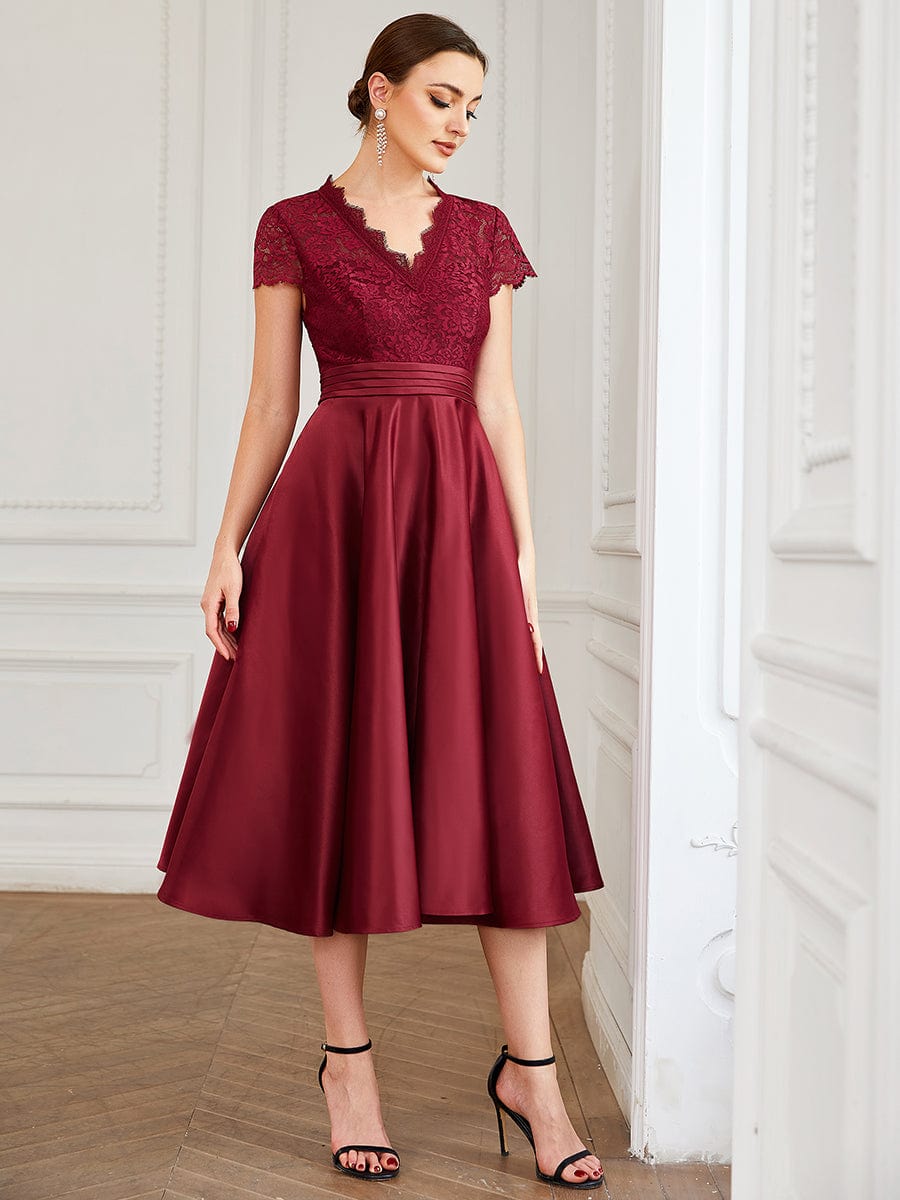 Model wearing a burgundy Weitese V-neck lace bodice dress with pockets, front view.