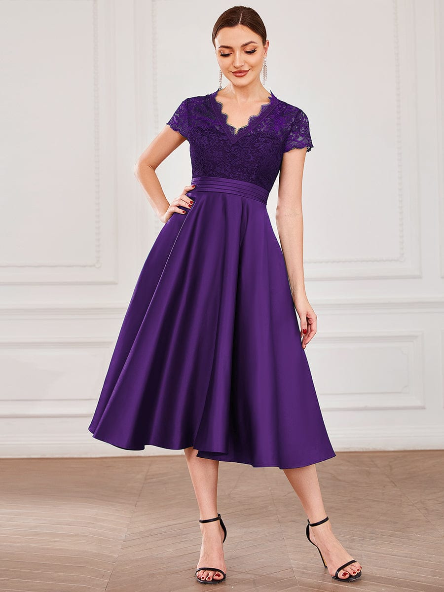 Model wearing a dark purple Weitese V-neck lace bodice dress with pockets.