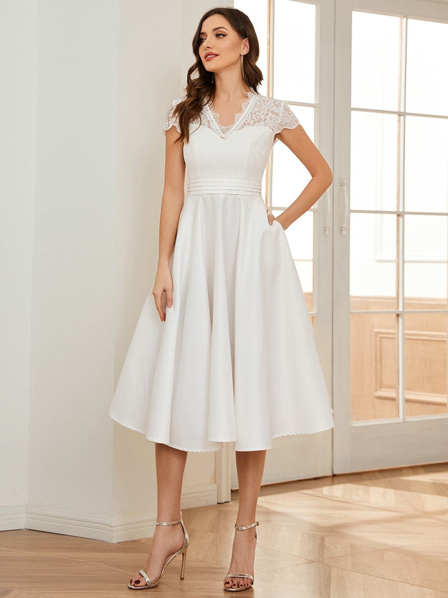 Model wearing a white Weitese V-neck lace bodice dress, suitable for various formal events.