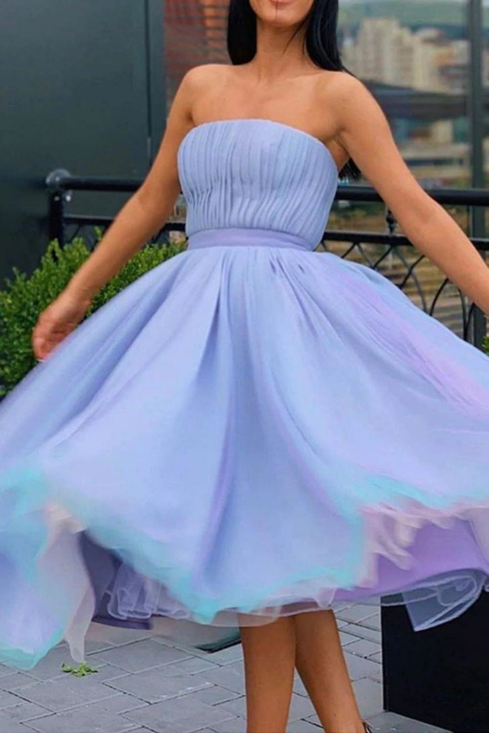 Model wearing a romantic pleated A-line short homecoming dress.