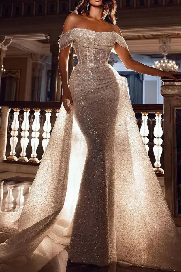 Off shoulder glitter mermaid gown with overskirt