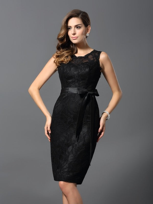 Model wearing a sophisticated short Weitese Mother of the Bride dress with a jewel neckline and lace details.