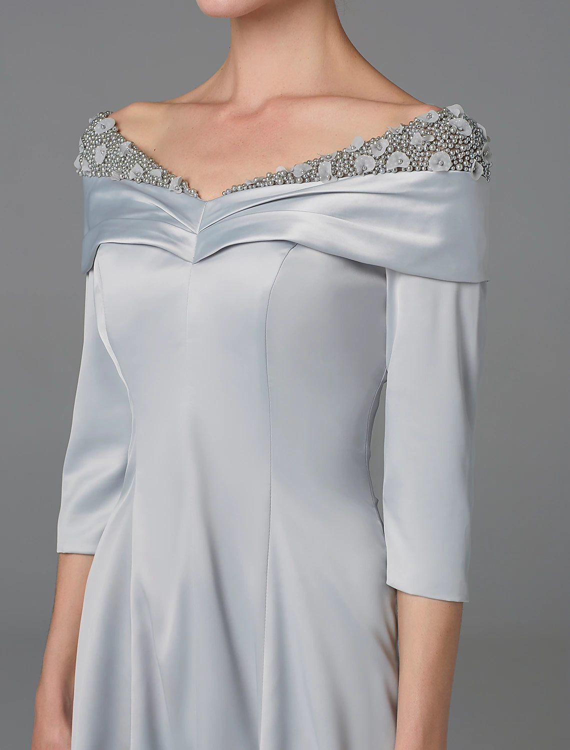 Woman in the A-line off-shoulder dress, captured in a dynamic walking pose.
