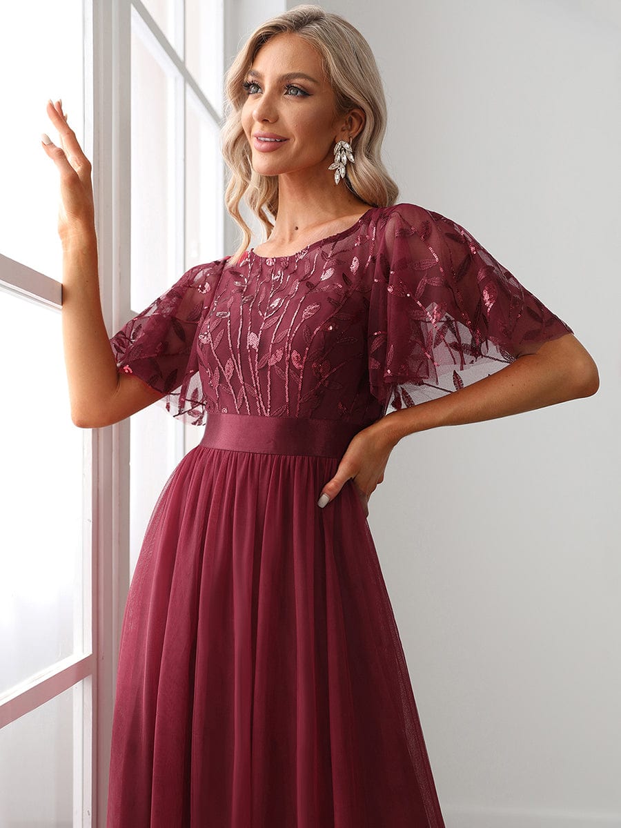 Close-up of the intricate sequin leaf detail on the burgundy Weitese maxi dress.