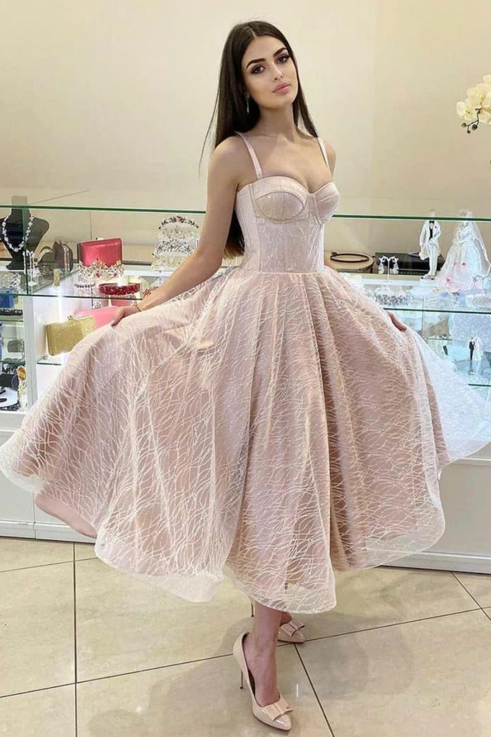 Model wearing a sparkling A-line glitter homecoming dress with spaghetti straps.