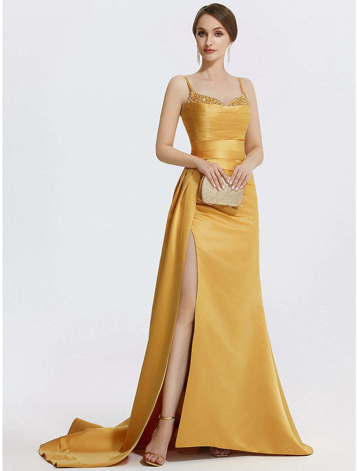 Full view of a sparkling A-line satin evening gown with spaghetti straps and a sweep train.