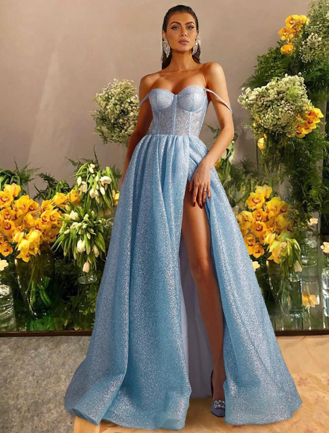 Model wearing a black sparkling A-line prom dress with a sweetheart neckline and a high slit.