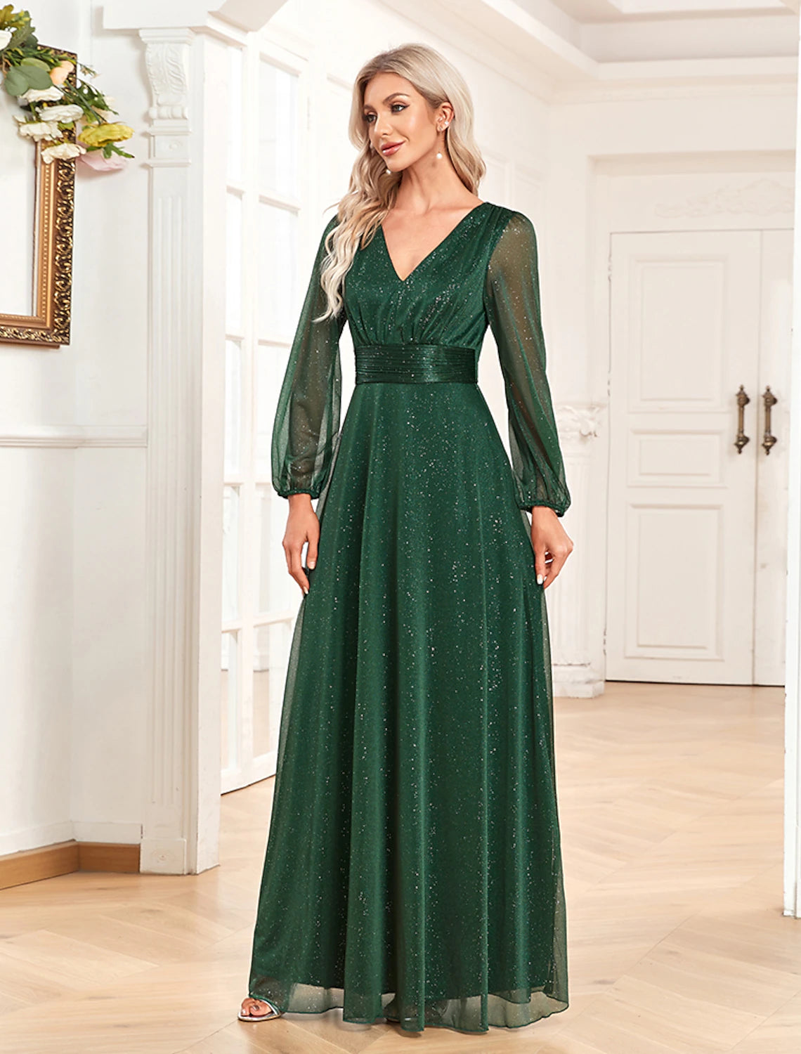 Close-up of the V-neckline and sequin embellished long sleeves on the evening gown.
