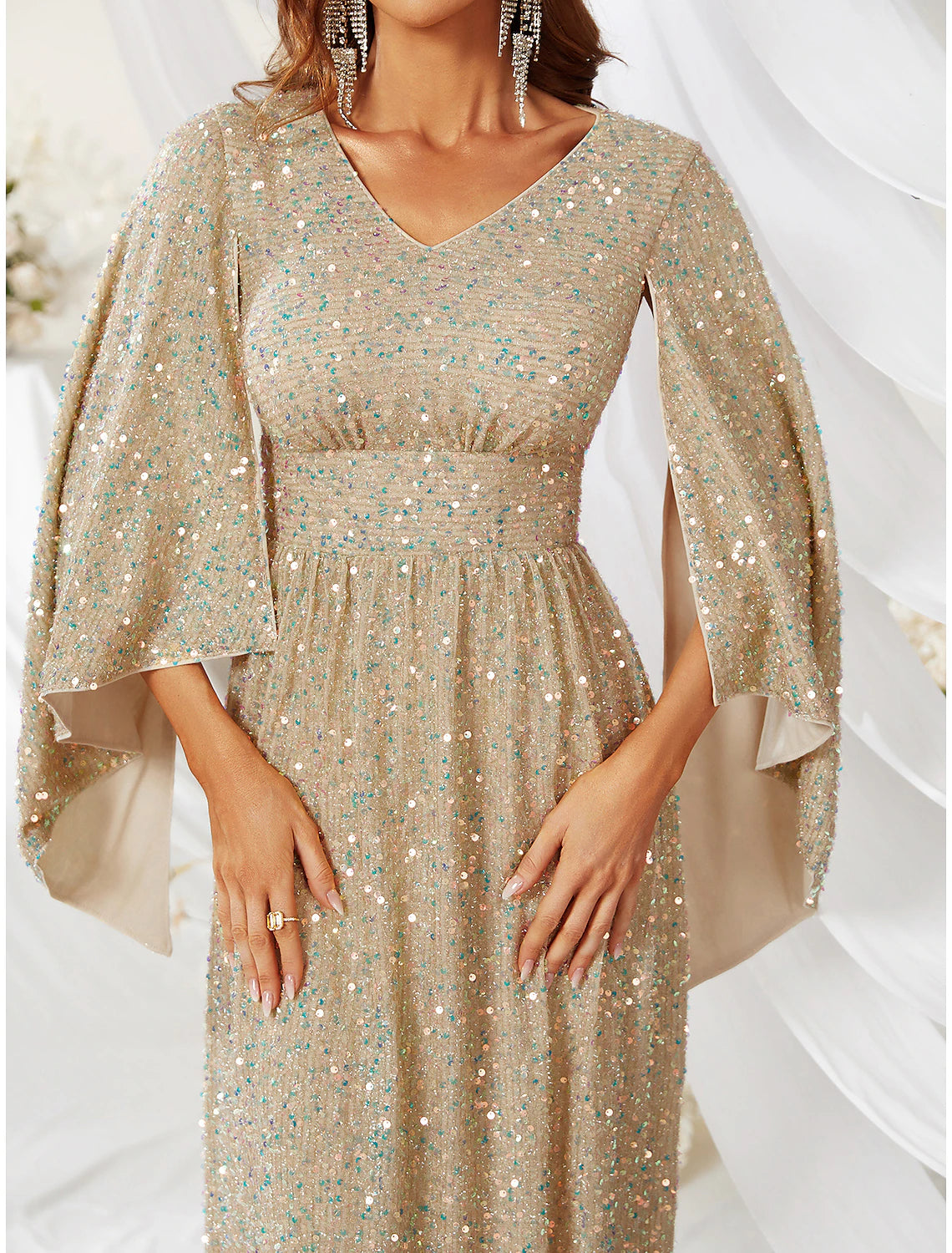 Close-up of the sequin detailing on the long sleeve of the evening gown.