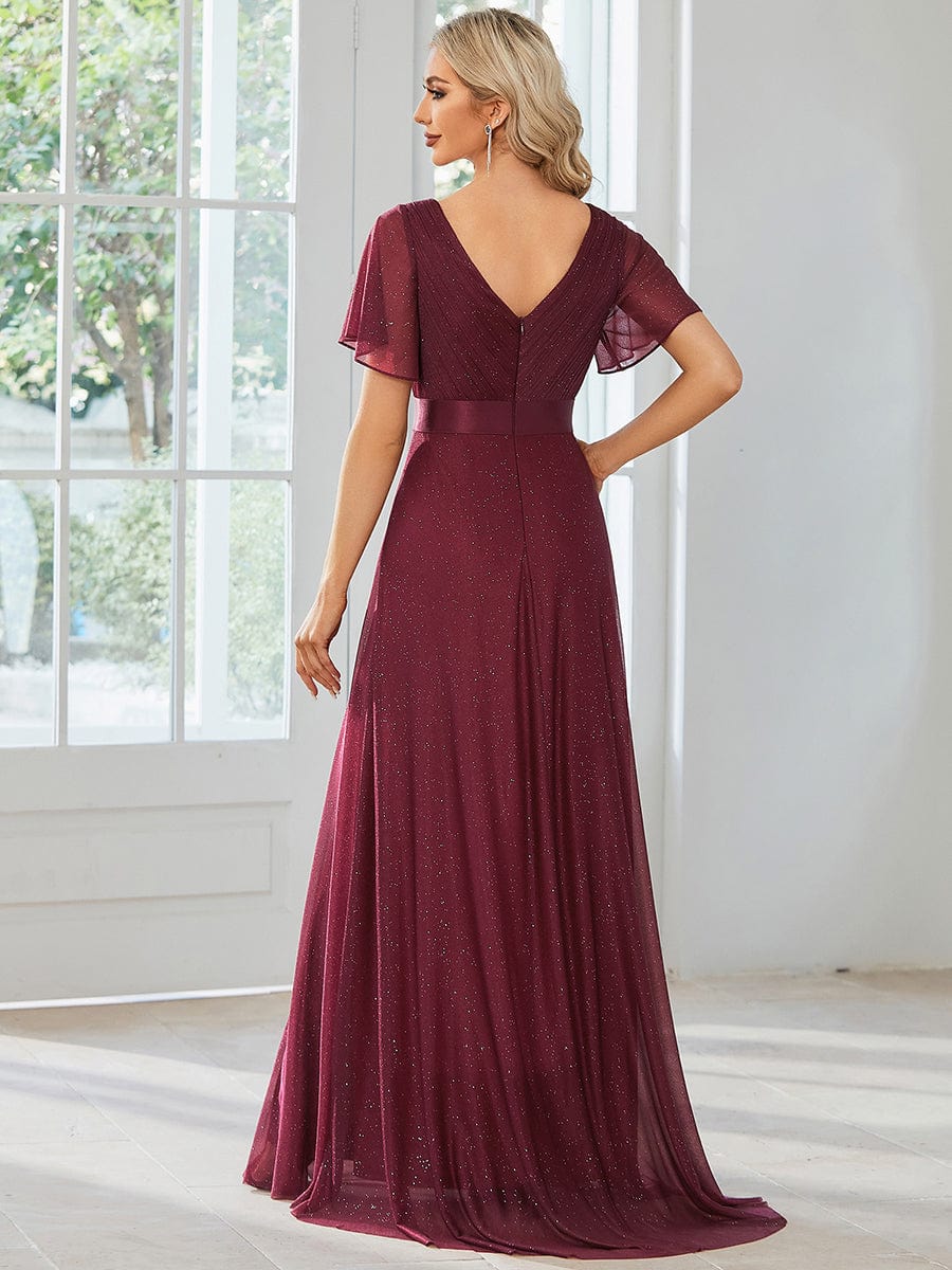 Side view of model in a sparkling red V-neck short sleeve evening dress.