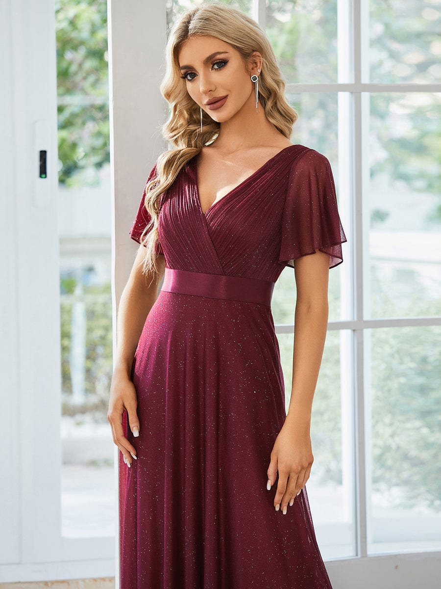Model posing in a sparkling red short sleeve V-neck formal dress.