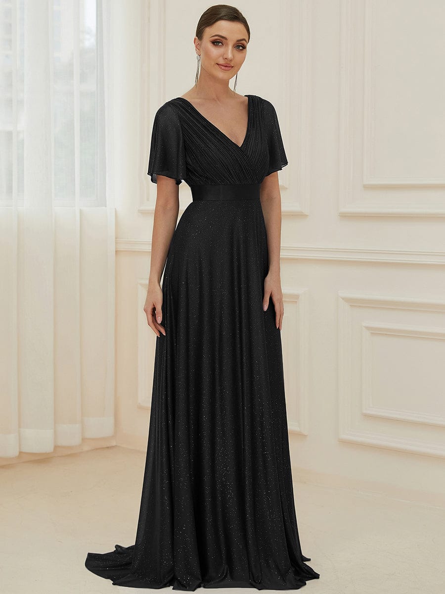 Model wearing a sparkling black A-line V-neck evening dress with short sleeves.