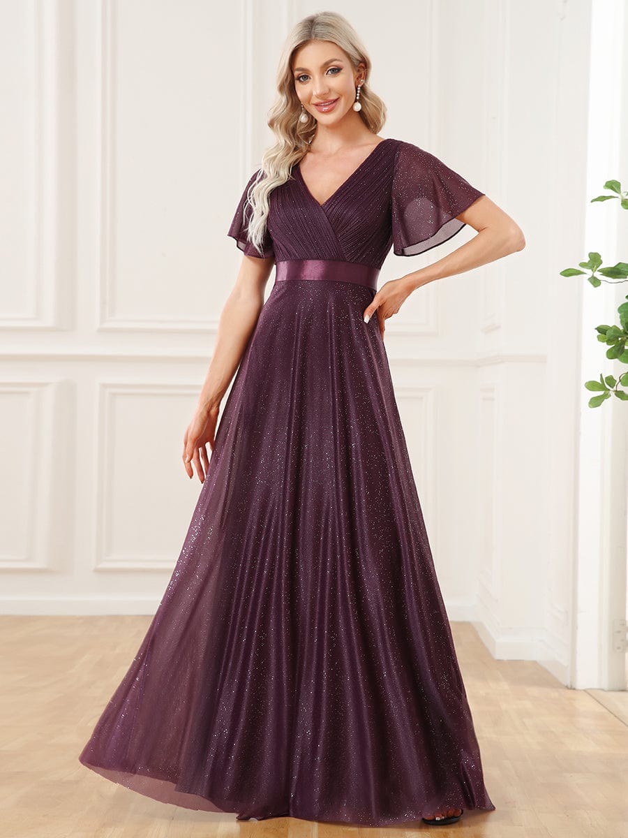 Model in a sparkling dark purple A-line V-neck evening dress with a ribbon waist.